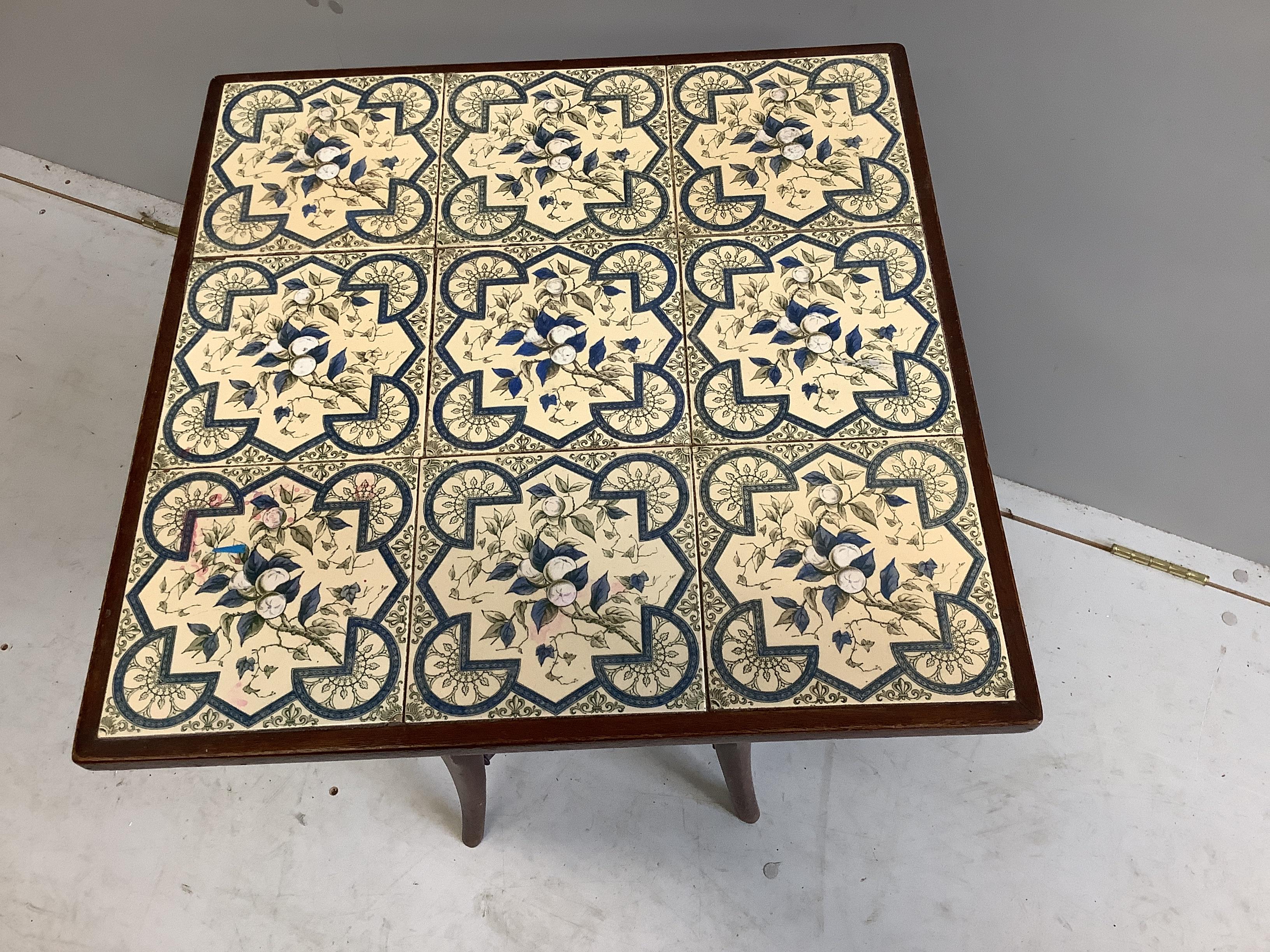 A late Victorian mahogany two tier tiled top occasional table, width 49cm, depth 49cm, height 67cm